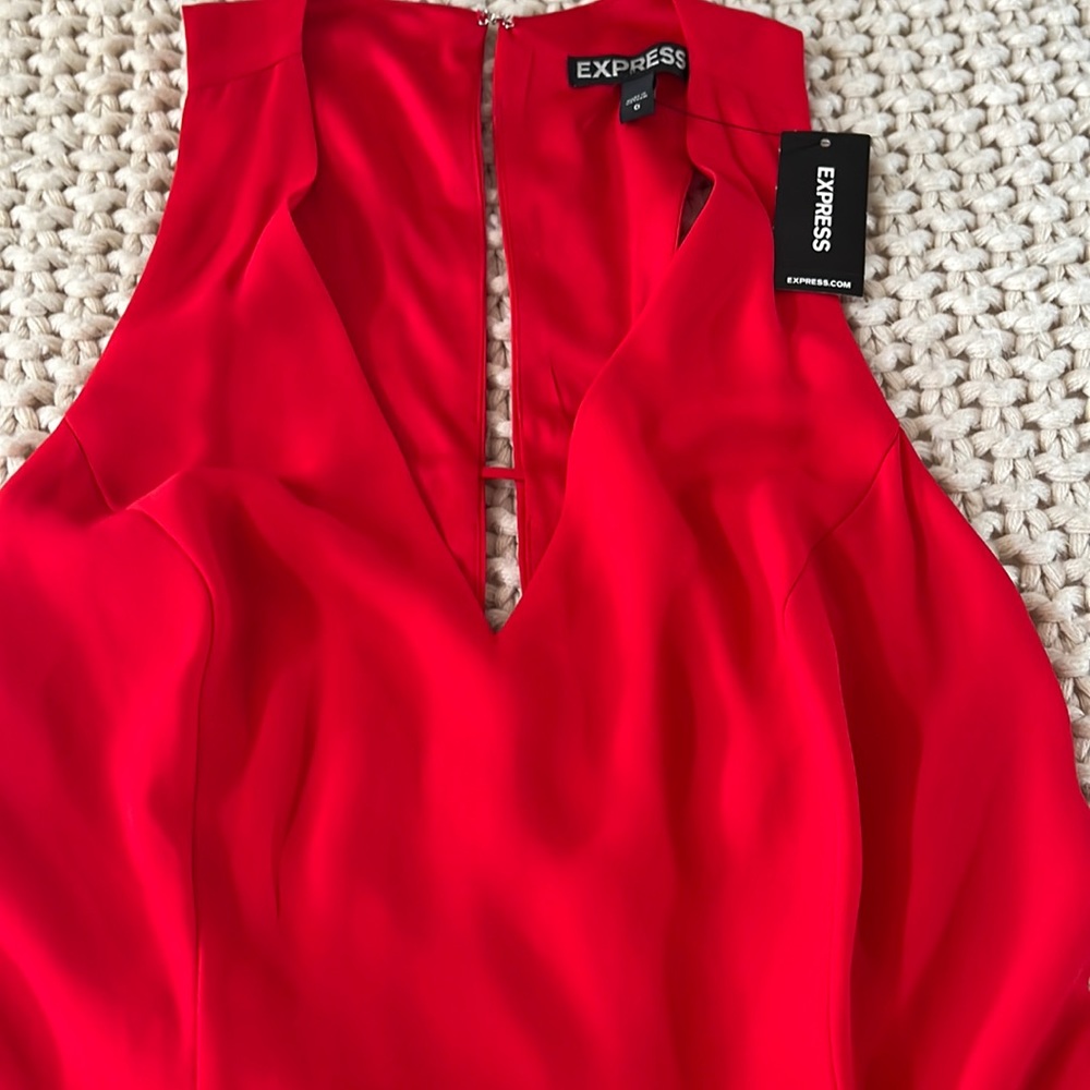 Red romper size 0 with tags. Romper has pockets. From express. Never worn.